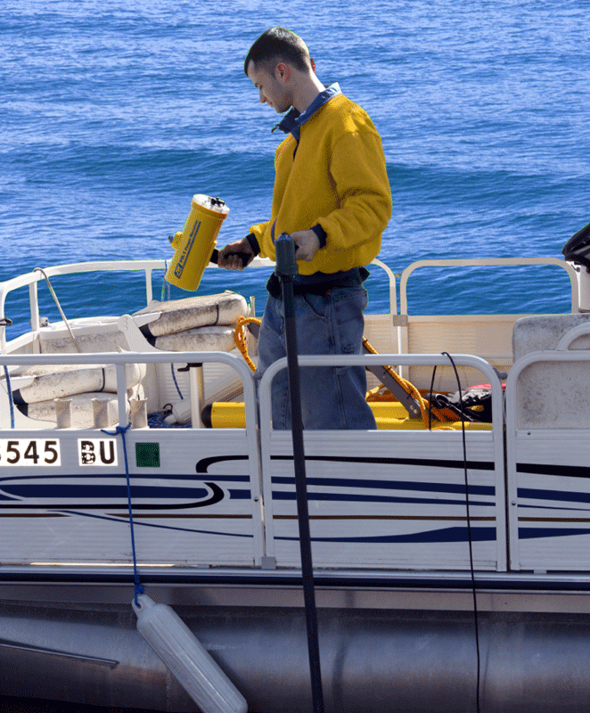 A man using the Diver Held Interrogator (DHI) and the boat deployment kit
