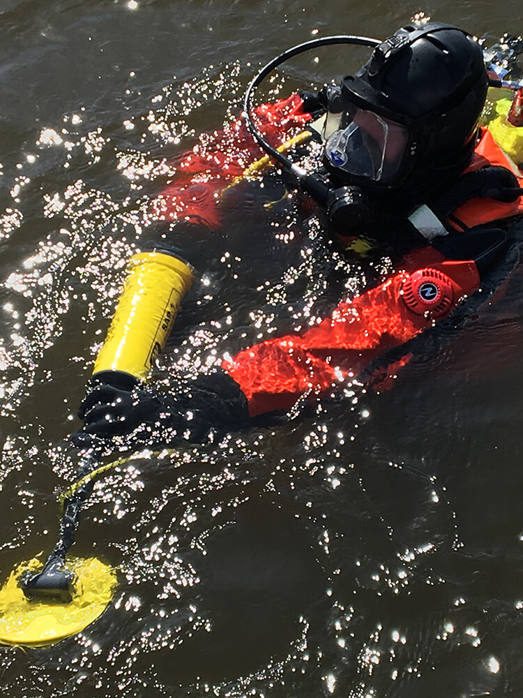 Diver holding a Search And Recovery Metal Detector (SAR)